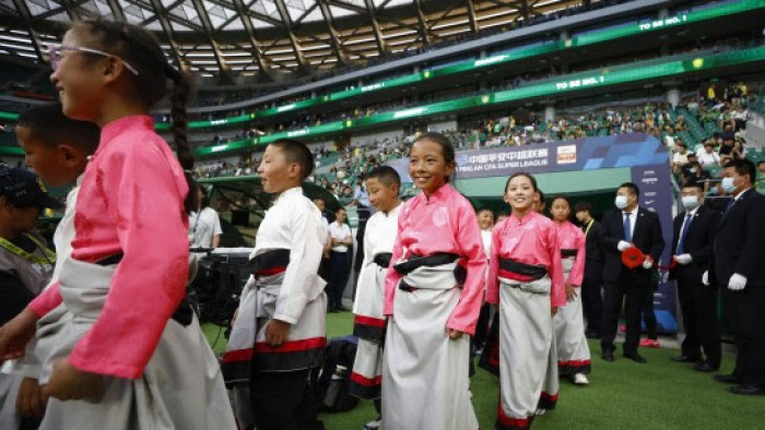 Tibetan teenagers watched a football game at the Beijing Workers' Stadium on Jun 2.
